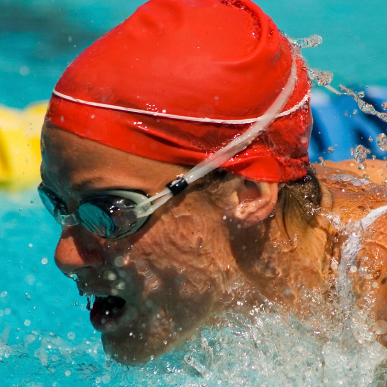 Femme fait des longueurs dans une piscine